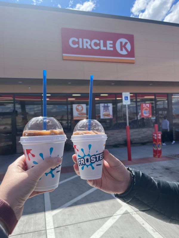 Two small Dr. Pepper flavored Circle K Frosters, held up in front of the Circle K.