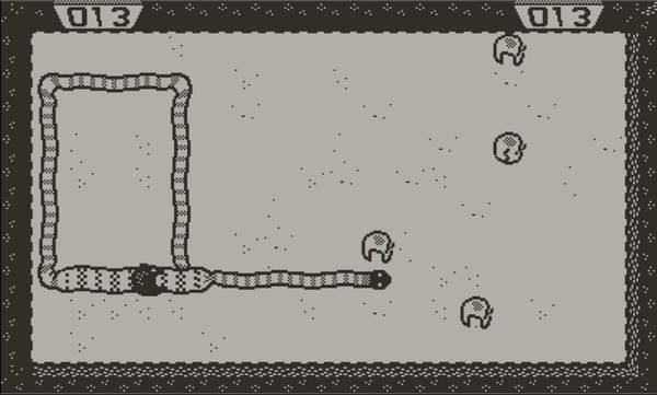 A snake with a body wall and one apple on its back nears an apple in a field of four apples