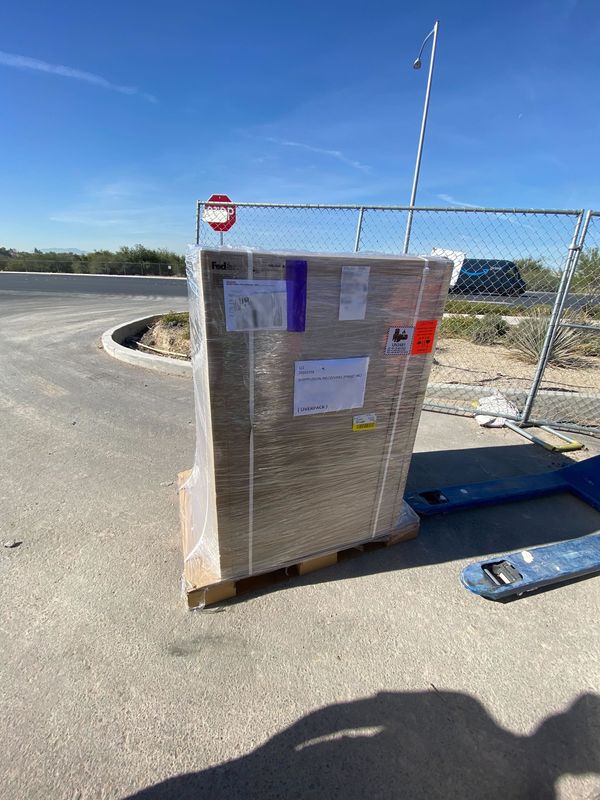 A pallet of Playdates addressed to Ship Fusion dropped off in a parking lot in the desert.