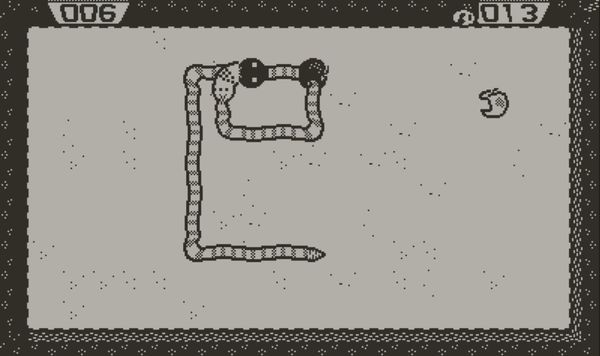 A snake in Snak jumping over itself while two apples work their way up its back