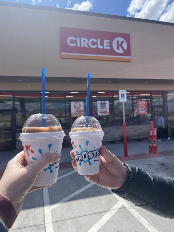 Two small Dr. Pepper flavored Circle K Frosters, held up in front of the Circle K.
